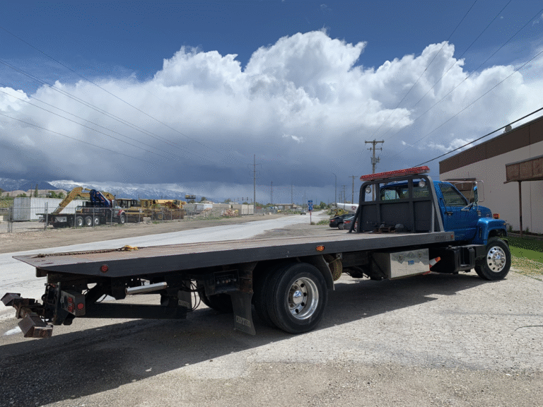 Flatbed tow truck loading a car on Craigieburn Road near Craigieburn Central under overcast sky